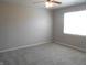 This bedroom is a blank slate with neutral walls and carpet and ceiling fan at 1615 Capra Ct, Beech Grove, IN 46107