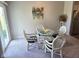 Bright dining area with a glass table, four chairs, and plenty of natural light at 1615 Capra Ct, Beech Grove, IN 46107
