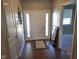 Inviting entryway with sidelights, stylish decor, and durable wood-look flooring welcomes you home at 1615 Capra Ct, Beech Grove, IN 46107