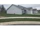 This home boasts vinyl siding and a well-maintained lawn at 1615 Capra Ct, Beech Grove, IN 46107