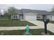Well-maintained home with an attached garage, a manicured lawn, and a functional mailbox at 1615 Capra Ct, Beech Grove, IN 46107