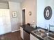 Kitchen area with black countertops, stainless steel appliances, and white cabinetry at 1615 Capra Ct, Beech Grove, IN 46107