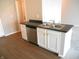 This kitchenette features stainless steel appliances, white cabinets, and laminate floors at 1615 Capra Ct, Beech Grove, IN 46107