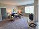 Comfortable living room features a large window, plush carpet, and contemporary furnishings at 1615 Capra Ct, Beech Grove, IN 46107
