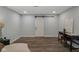 Finished basement area with modern flooring, work desk and sliding barn door at 16491 Wheatley Ct, Fishers, IN 46040
