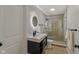 Modern bathroom featuring vanity with sleek countertop, illuminated mirror, and glass-enclosed shower at 16491 Wheatley Ct, Fishers, IN 46040