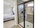 Bathroom showcasing a shower with black trim and view into the bedroom at 16491 Wheatley Ct, Fishers, IN 46040