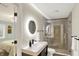 Modern bathroom with a glass-enclosed shower, vanity, and a lighted round mirror at 16491 Wheatley Ct, Fishers, IN 46040