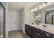 Bathroom featuring a double sink vanity with modern fixtures and a decorative floral arrangement at 16491 Wheatley Ct, Fishers, IN 46040