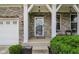 Inviting front entrance with stone accents, white pillars, and manicured landscaping at 16491 Wheatley Ct, Fishers, IN 46040