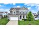 Charming two-story home featuring stone accents, a well-manicured lawn, and an attached two car garage at 16491 Wheatley Ct, Fishers, IN 46040