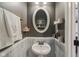 Charming half bathroom with a pedestal sink, decorative mirror, and fresh neutral paint at 16491 Wheatley Ct, Fishers, IN 46040