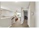 Hallway showing the living room, ceiling fan, and an open doorway into another room at 16491 Wheatley Ct, Fishers, IN 46040