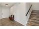 Inviting entryway with wood floors, staircase, and a bench offering a welcoming space at 16491 Wheatley Ct, Fishers, IN 46040