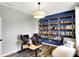 Bright home office with custom shelving and comfortable seating area, perfect for remote work at 16491 Wheatley Ct, Fishers, IN 46040