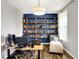 Bright home office with custom shelving and comfortable seating area, perfect for remote work at 16491 Wheatley Ct, Fishers, IN 46040