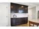 This kitchen has dark cabinets, white subway tile backsplash and hardwood floors at 16491 Wheatley Ct, Fishers, IN 46040