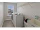 Laundry room features modern washer and dryer with storage, with a window allowing natural light at 16491 Wheatley Ct, Fishers, IN 46040