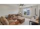 Cozy living room with comfortable seating, a ceiling fan, and a view to the outside at 16491 Wheatley Ct, Fishers, IN 46040
