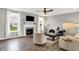 A naturally lit open living space with a fireplace, hardwood floors, and comfortable seating at 16491 Wheatley Ct, Fishers, IN 46040