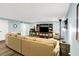 A finished basement living room features a large entertainment center, a comfortable couch, and wood-look floors at 16491 Wheatley Ct, Fishers, IN 46040
