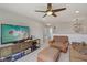Bright living room with a ceiling fan, comfortable seating, and a large TV at 16491 Wheatley Ct, Fishers, IN 46040