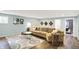Bright, finished basement living room featuring a comfortable couch, stylish rug, and decorative wall accents at 16491 Wheatley Ct, Fishers, IN 46040