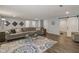 Large living room with hardwood floors, a decorative rug, and comfortable seating at 16491 Wheatley Ct, Fishers, IN 46040