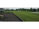 Community playground and soccer field area for recreational activities, including swings and goals at 16491 Wheatley Ct, Fishers, IN 46040