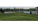 A serene community pool is enclosed by a black fence, featuring lounge chairs and a glimpse of neighborhood homes at 16491 Wheatley Ct, Fishers, IN 46040