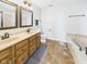 Spacious bathroom with double sinks, two mirrors, and a corner tub, perfect for unwinding after a long day at 170 Straughn Ln, Westfield, IN 46074