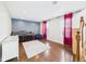 Spacious bonus room with hardwood floors, area rug, and blue accent wall at 170 Straughn Ln, Westfield, IN 46074