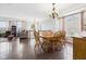 Bright dining area featuring hardwood floors, chandelier, and a smooth transition to the living area with lots of natural light at 170 Straughn Ln, Westfield, IN 46074