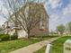 Inviting townhouse showcases a private balcony, attached garage, and a charming tree-lined walkway at 170 Straughn Ln, Westfield, IN 46074