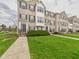 Well-maintained brick townhomes boast lush green lawns at 170 Straughn Ln, Westfield, IN 46074
