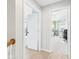 Hallway leading to a bright, well-lit room featuring a large window, perfect for a home office or music studio at 170 Straughn Ln, Westfield, IN 46074