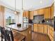 Cozy kitchen featuring wood cabinets, an island with seating, and stainless steel appliances at 170 Straughn Ln, Westfield, IN 46074