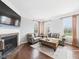 Comfortable living room featuring a fireplace, large windows, and a neutral color palette at 170 Straughn Ln, Westfield, IN 46074