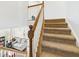 Carpeted staircase with white wood trim offers a warm and inviting transition to the upper levels of the home at 170 Straughn Ln, Westfield, IN 46074