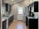 Modern kitchen featuring sleek, dark cabinetry, stainless steel appliances, and a convenient washer/dryer combo at 1922 N Cherry St, Columbus, IN 47201
