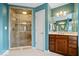 Bathroom with a glass enclosed shower, vanity, mirror, and blue walls at 20251 Dayspring Ct, Noblesville, IN 46062