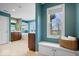 Bright bathroom featuring a soaking tub, double vanity, tiled floor and a storage bench by a window at 20251 Dayspring Ct, Noblesville, IN 46062