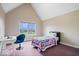 Cozy bedroom with a vaulted ceiling, a plush chair, and a bright window overlooking the front yard at 20251 Dayspring Ct, Noblesville, IN 46062