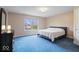 The bedroom features neutral walls, blue carpeting, a double window, and generous lighting at 20251 Dayspring Ct, Noblesville, IN 46062