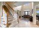 Spacious foyer with a grand staircase and abundant natural light welcomes guests with an elegant ambiance at 20251 Dayspring Ct, Noblesville, IN 46062