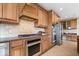 Well-equipped kitchen boasts stainless steel appliances and custom cabinetry for ample storage and a modern aesthetic at 20251 Dayspring Ct, Noblesville, IN 46062