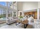 Open concept living area with backyard pool view, tall ceilings, and seamless access to the gourmet kitchen at 20251 Dayspring Ct, Noblesville, IN 46062