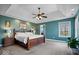 The main bedroom features a tray ceiling, neutral carpeting, and a large window with a scenic backyard view at 20251 Dayspring Ct, Noblesville, IN 46062