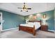The main bedroom features a tray ceiling, neutral carpeting, and a large window with a scenic backyard view at 20251 Dayspring Ct, Noblesville, IN 46062