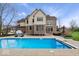 Relaxing in-ground pool with ample patio space and beautiful views of the house and surrounding yard at 20251 Dayspring Ct, Noblesville, IN 46062